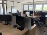 a desk with two computer monitors and a monitor on it