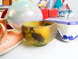 a lot of different bowls and cups on the table