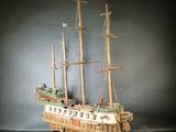 a wooden model of a ship on a table