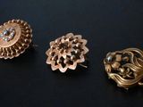 three pairs of gold tone earrings and a broochet