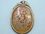 an image of a picture of a pendant with a flower design on it