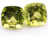 pair of yellow quartz cushion cut gems on a white background