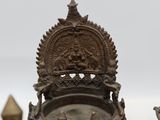 a statue of a man sitting on a throne next to other statues