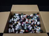 a cardboard box filled with bottles of alcohol on a black surface