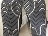 the soles of a pair of black and white shoes on a white surface