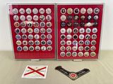two display cases with badges on them on a table