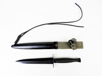 a knife and a knife holder on a white surface