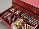 a red box with silverware in it on a table