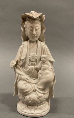statue of a woman holding a child in her lap