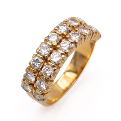 a close up of a gold ring with diamonds on a white background