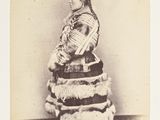 an old photo of a woman in a dress