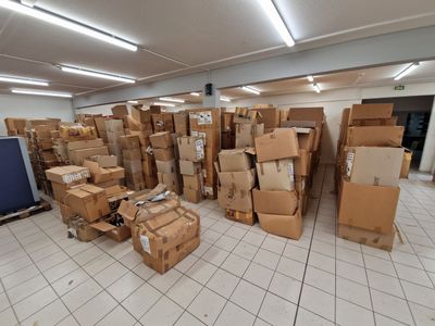 many boxes stacked on top of each other in a room