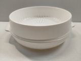 a white bowl sitting on top of a white table