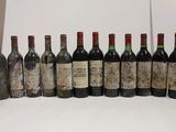 several bottles of wine are lined up in a row on a table