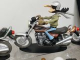 a figurine of a man riding a motorcycle on a table