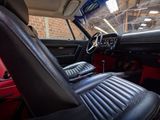 the interior of a classic car with red leather seats and black leather trims