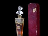 an image of a bottle of perfume on a black background