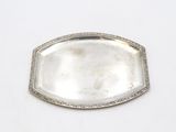 an antique silver tray with a diamond border around the edge