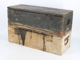 two trunks stacked on top of each other on a white surface