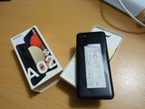 a cell phone that is sitting on a table next to a book