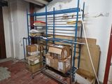 boxes are stacked on a metal rack in an empty room