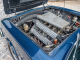 a blue car with an engine in the trunk
