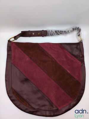 the purse is made of leather and has a brown and red stripe pattern