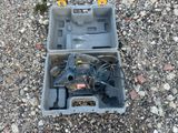 a tool box that has a drill in it on the ground