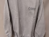 a grey sweatshirt with the word core on it hanging on a hanger