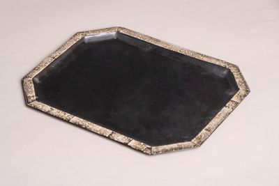 an image of a black and gold tray on a white table
