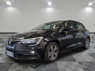 a black car is parked on a checkered floor in a garage