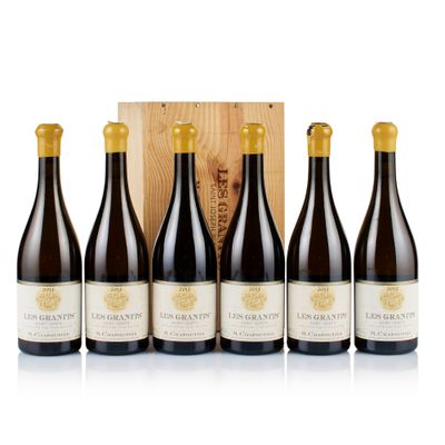 four bottles of wine in front of a wooden box