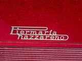 a close up of a red car with a logo on it