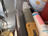 a pile of assorted items sitting on top of a stove