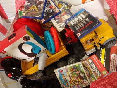 a pile of toys and games in a plastic container