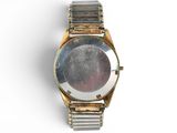 a watch that is sitting on a white surface
