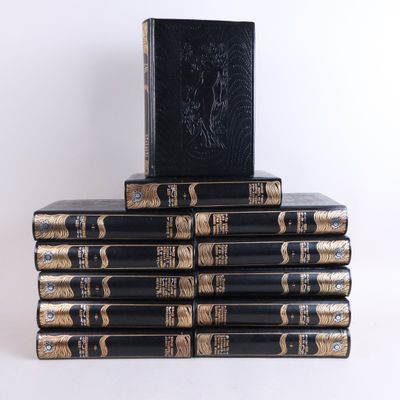books stacked on top of each other on a white surface