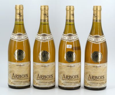 four bottles of wine are lined up on a white surface