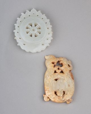 two pieces of carved food sitting on a table