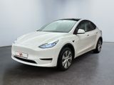 a white tesla model x parked in a white room