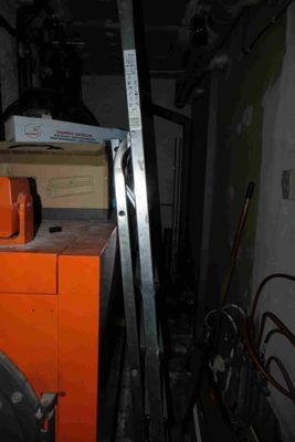 an orange cabinet in the middle of a room with a ladder