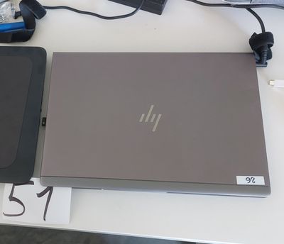 a laptop computer sitting on top of a white table