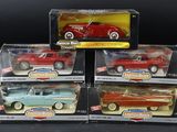 three red and blue toy cars in boxes on a black surface