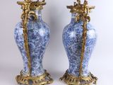 pair of blue and white vases with gold accents on a white background