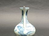 a small blue and white vase sitting on a table