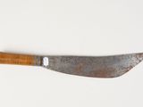 a close up of a knife with a wooden handle on a white surface