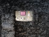 a small electronic device sitting on top of a pile of fur