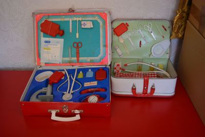 two suitcases that are sitting on a red table
