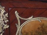 a mirror that is sitting next to a wooden cabinet