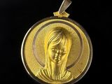 a close up of a gold medal on a black background